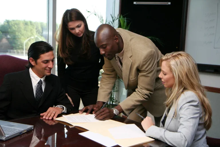group of mediation specialist looking over notes