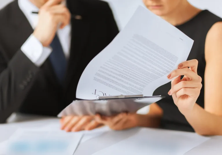 business, office, law and legal concept - picture of man and woman hand signing contract paper